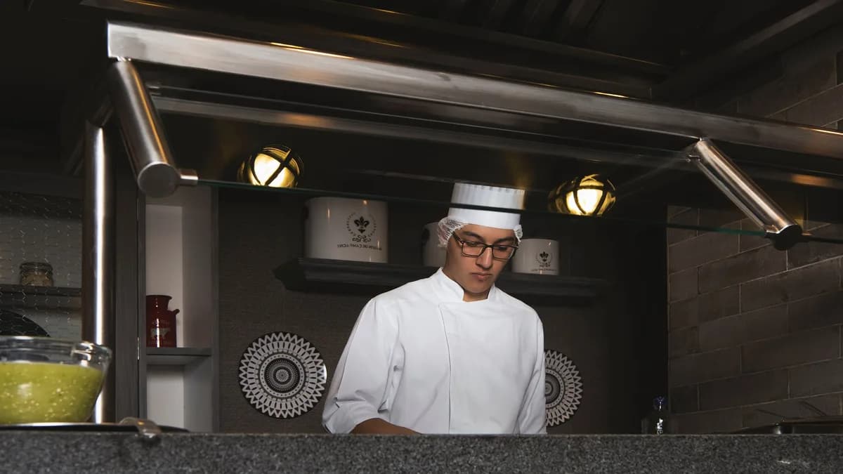Restaurant kitchen manager reviewing preventive maintenance schedule with service technician