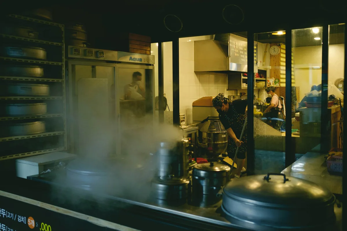 Licensed technician servicing restaurant grease trap with vacuum truck in Los Angeles