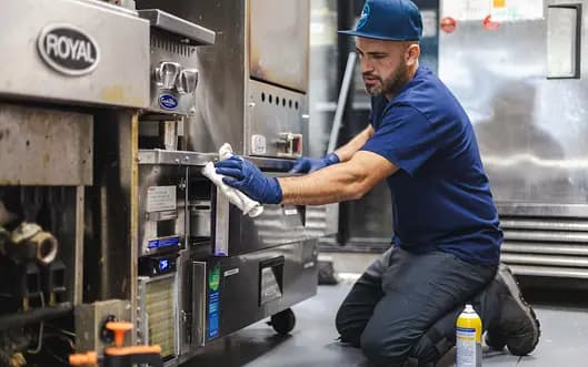 CLEAN ICE technician performing preventative maintenance on a commercial ice machine in a Southern California restaurant kitchen