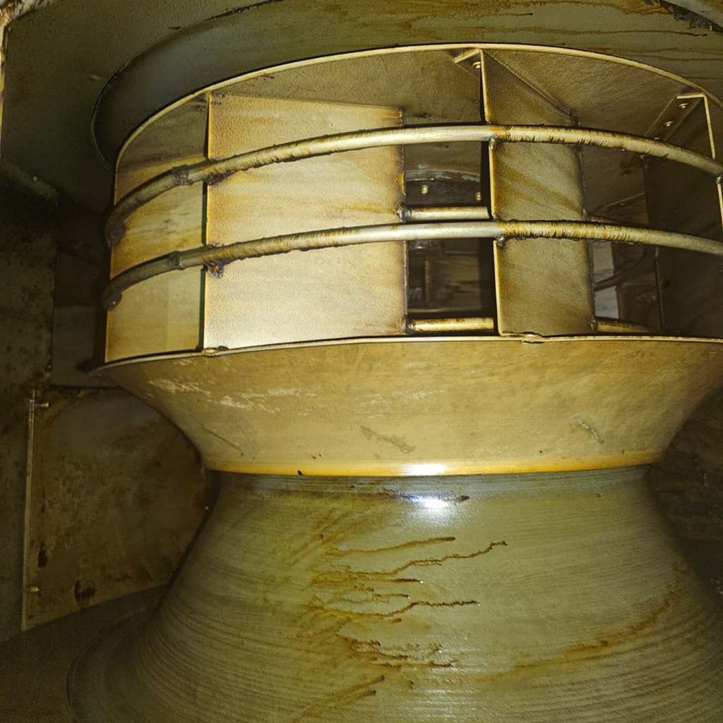 Commercial kitchen exhaust fan housing coated in grease before cleaning
