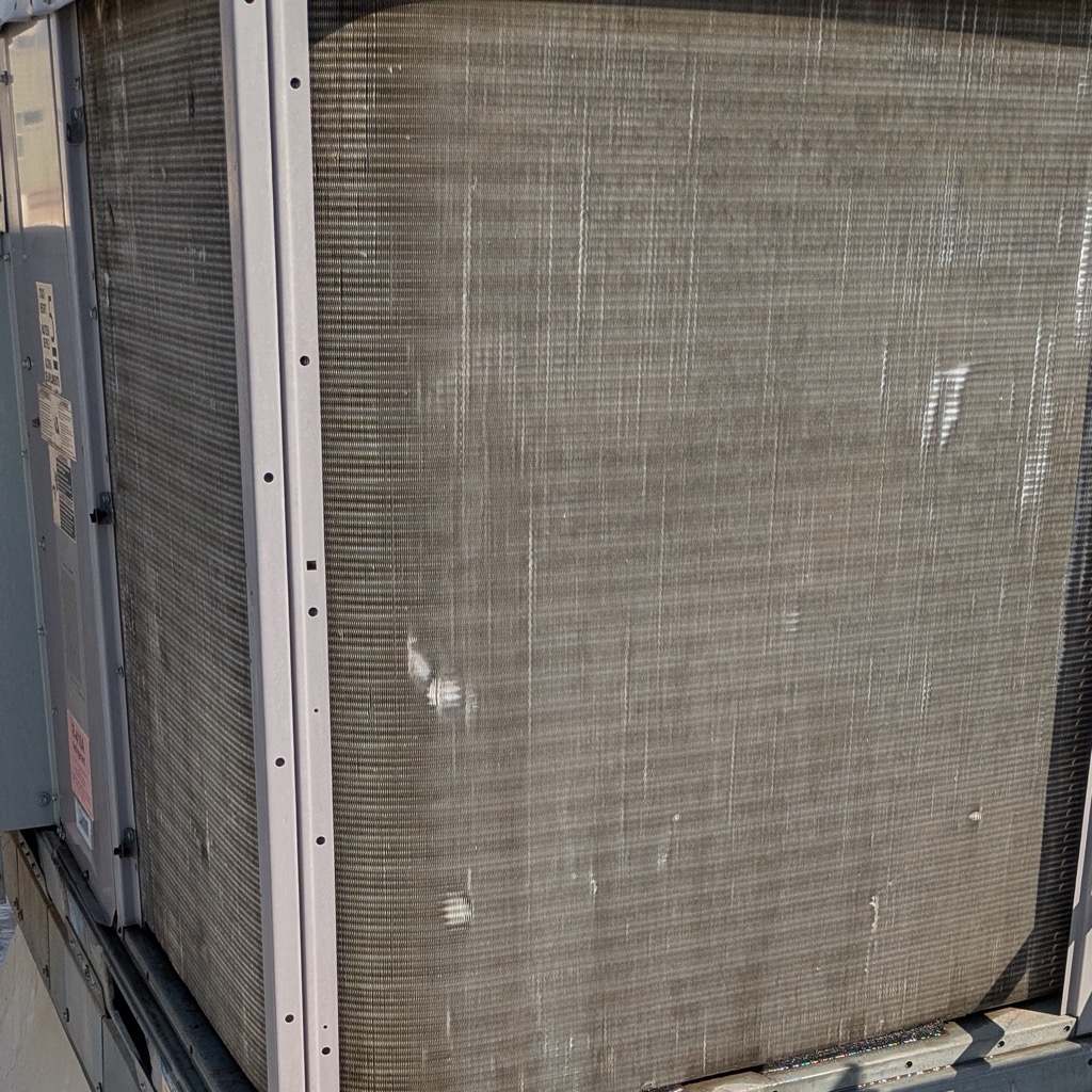The same condenser coil washed clean across the full face