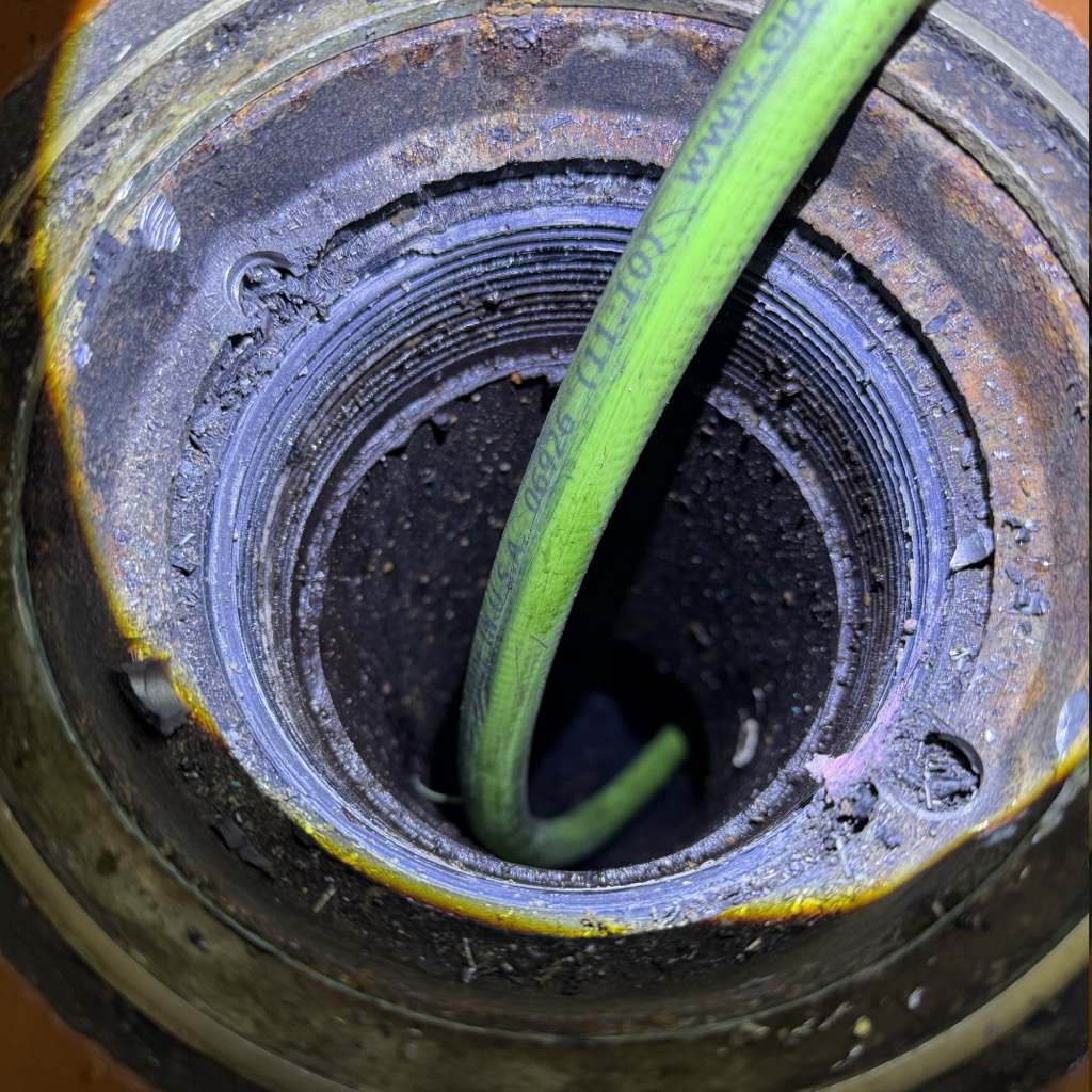 Jetter hose fed into a commercial kitchen grease line cleanout