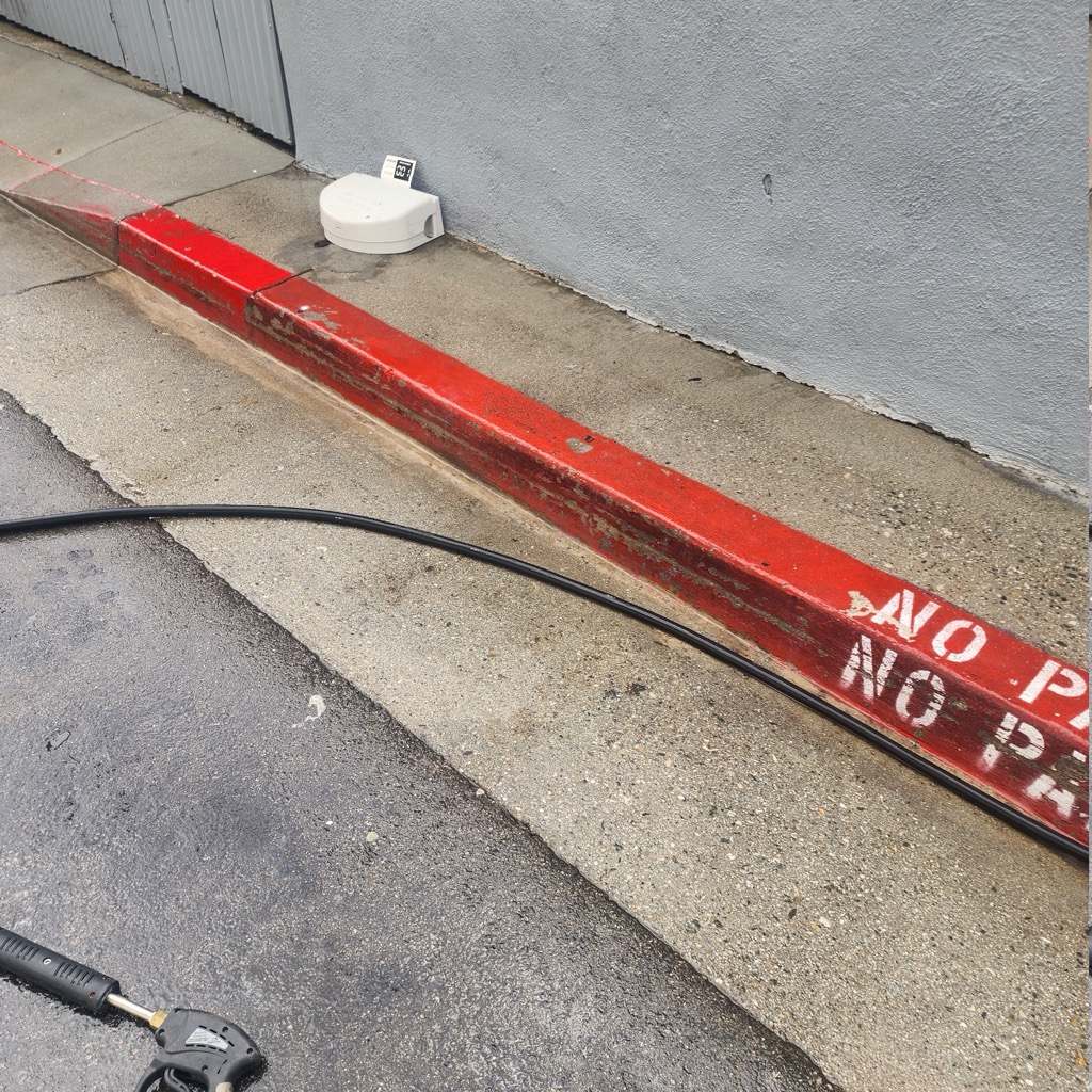 The same curb pressure washed back to clean paint